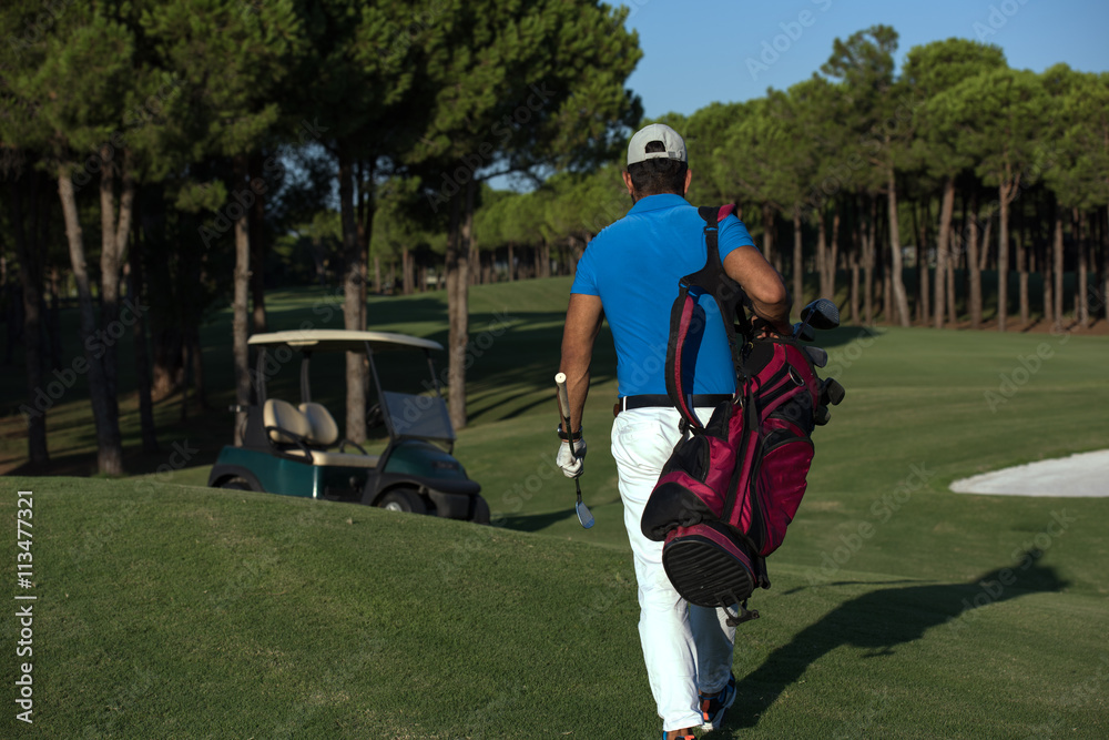 Obraz premium golfer walking and carrying golf bag