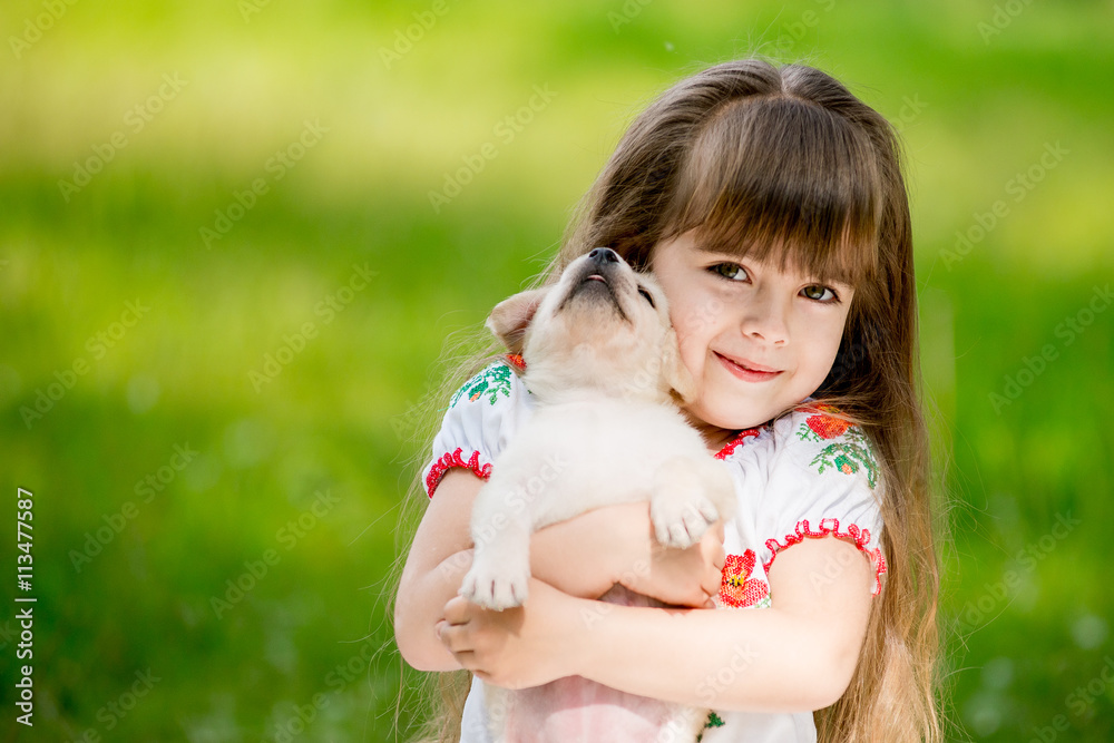 Little girl with a Golden retriever puppy Little girl with a Golden retriever puppy