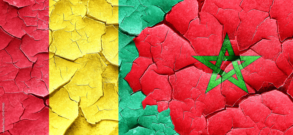 Guinea flag with Morocco flag on a grunge cracked wall