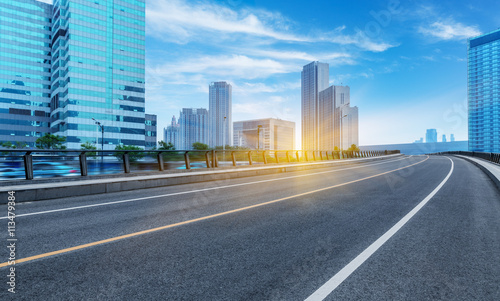 Fototapeta Naklejka Na Ścianę i Meble -  clean road with modern buildings background