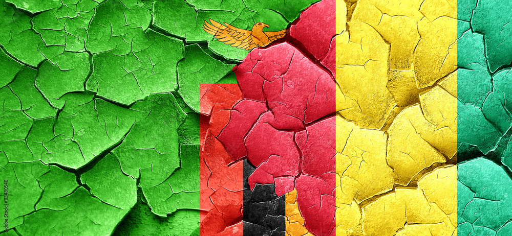 Zambia flag with Guinea flag on a grunge cracked wall