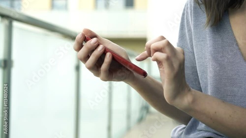 Wallpaper Mural Woman hands using smartphone sitting on terrace, 4K
 Torontodigital.ca