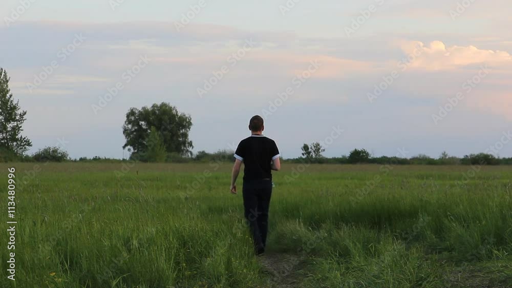 Man walks through the meadow ahead Man walks through the meadow ahead