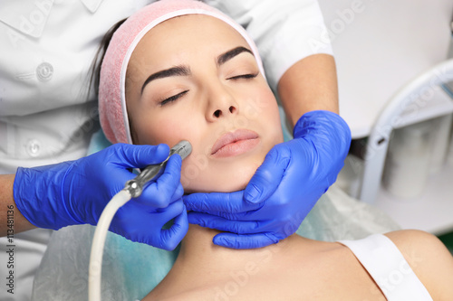 Young woman having face pro...