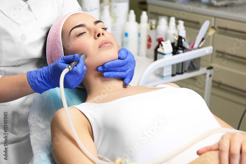 Young woman having face pro...