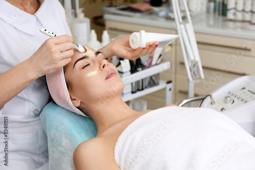 Young woman having face pro...