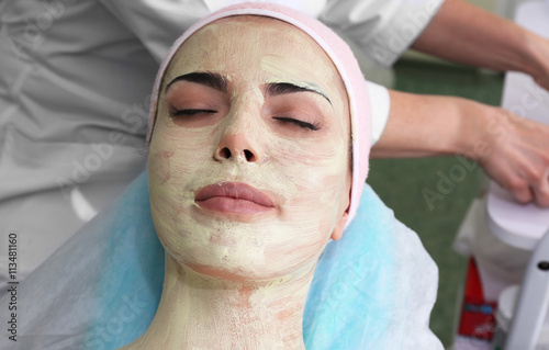 Young woman having face pro...