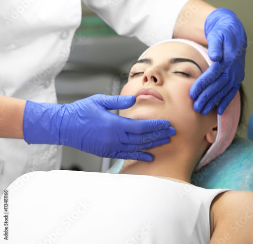 Young woman having face mas...