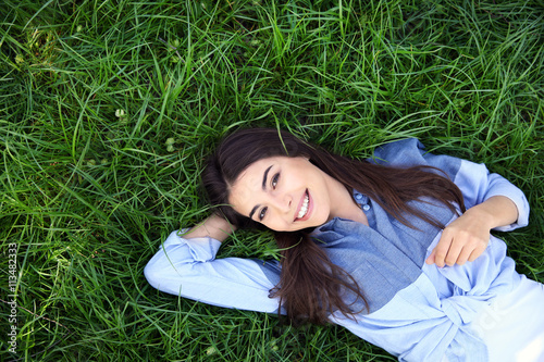 Beautiful girl lying on gre...