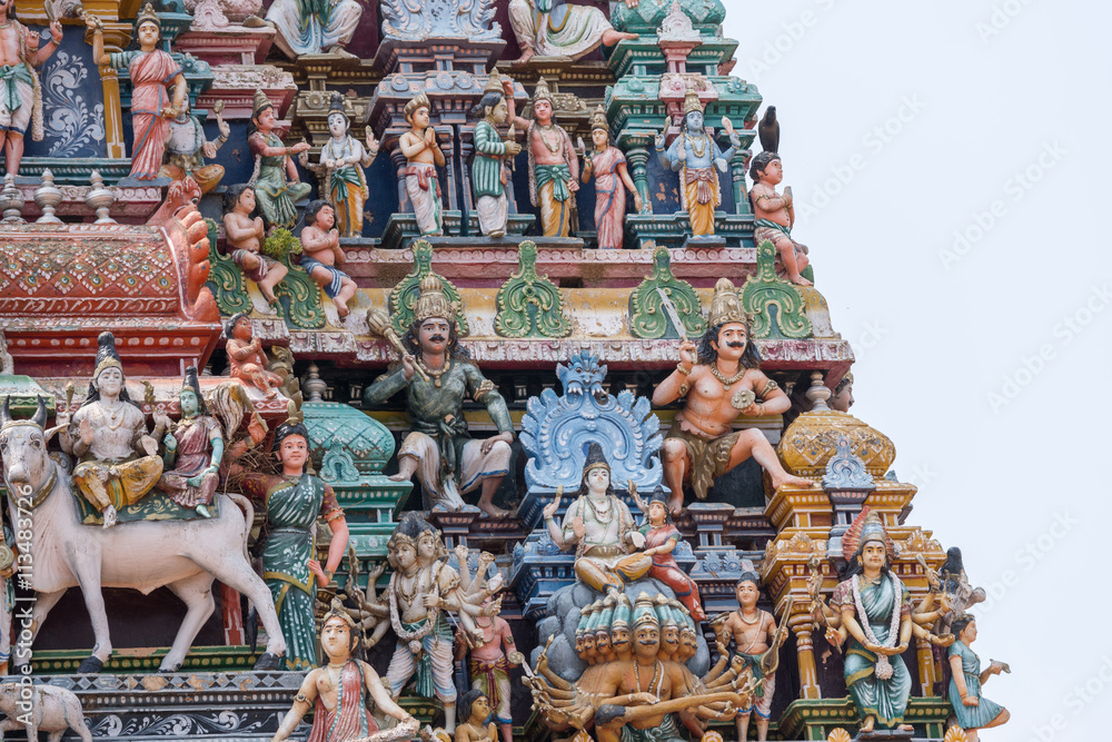 Fototapeta premium Chettinad, India - October 17, 2013:Detail of the Shiva temple gopuram at Kottaiyur shows Shiva and Parvati residing on Himalayan Kailash mountain on top of multi-headed Ravana. 