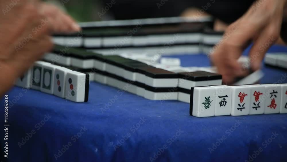 Time lapse of hands playing mah jong at People's square park in Shanghai, China 