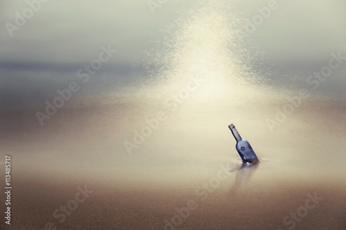 Bottle with message in sea at dusk