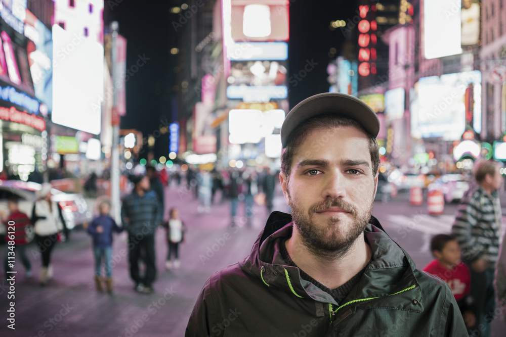 Portrait of confident man standing on illuminated street Portrait of confident man standing on illuminated street