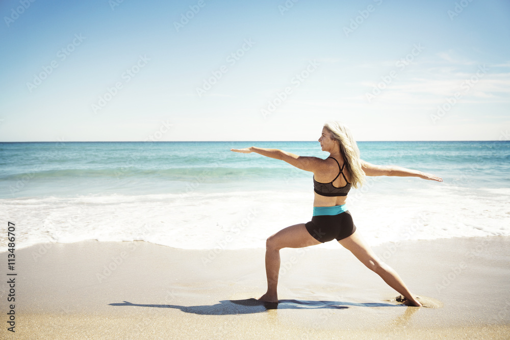 Beautiful woman practicing yoga on the Delray Beach Beautiful woman practicing yoga on the Delray Beach