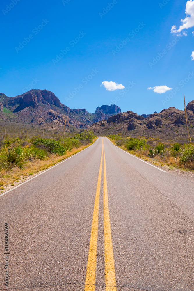 Beautiful cinematic view of the road under the blue cloudless sky in America Beautiful cinematic view of the road under the blue cloudless sky in America