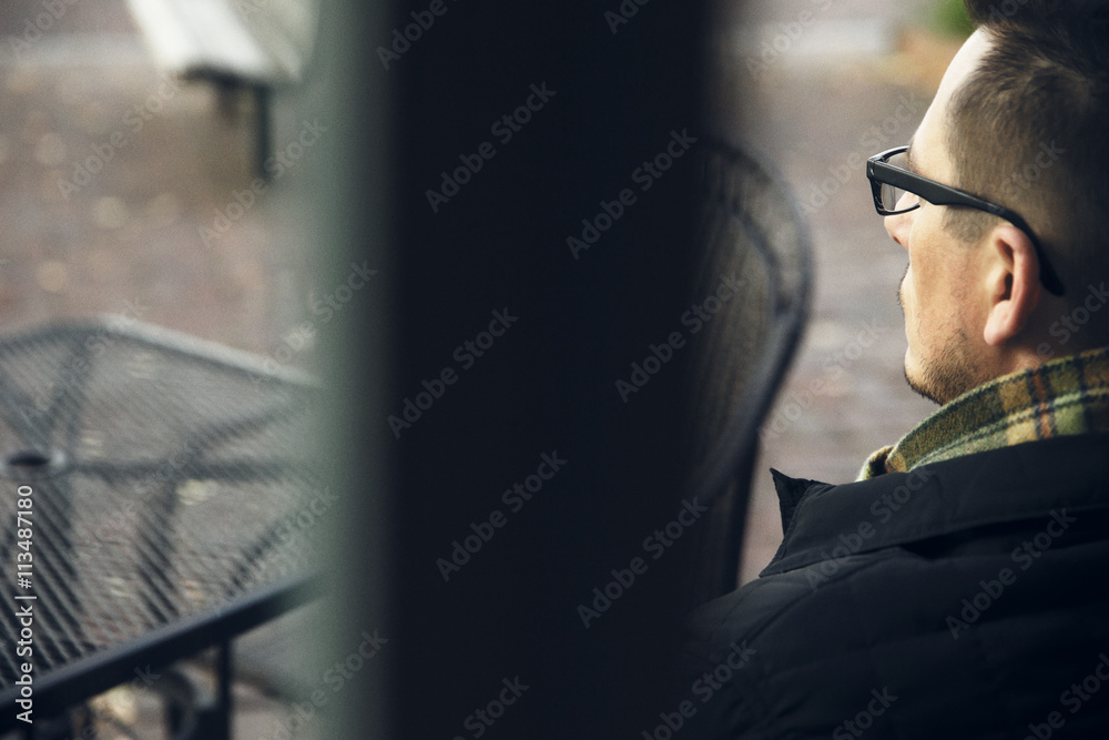 Rear view of thoughtful man relaxing outdoors Rear view of thoughtful man relaxing outdoors