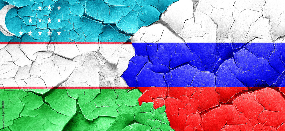Uzbekistan flag with Russia flag on a grunge cracked wall