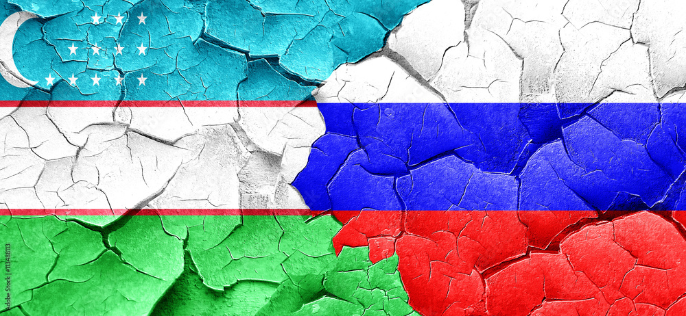 Uzbekistan flag with Russia flag on a grunge cracked wall Uzbekistan flag with Russia flag on a grunge cracked wall