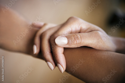 Cropped image of woman touching hand photo