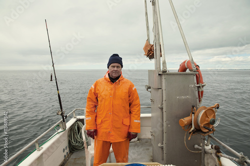 Portrait of fisherman standing on boat photo
