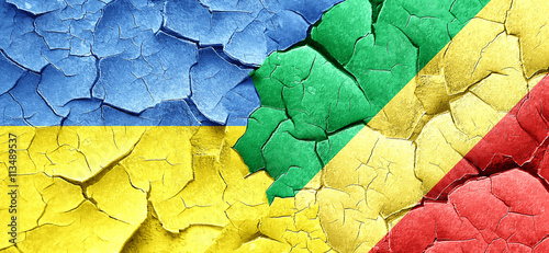 Ukraine flag with congo flag on a grunge cracked wall