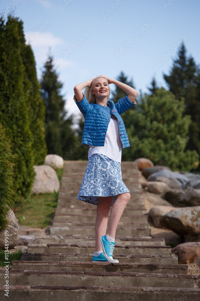 Portrait of beautiful girl posing in the Park fashion style skirt jacket