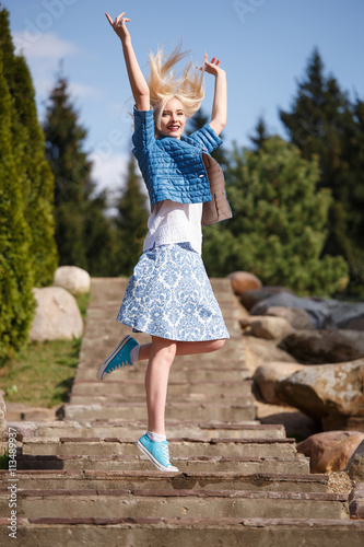 Portrait of beautiful girl posing in the Park fashion style skirt jacket