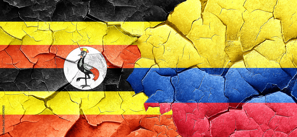 Uganda flag with Colombia flag on a grunge cracked wall