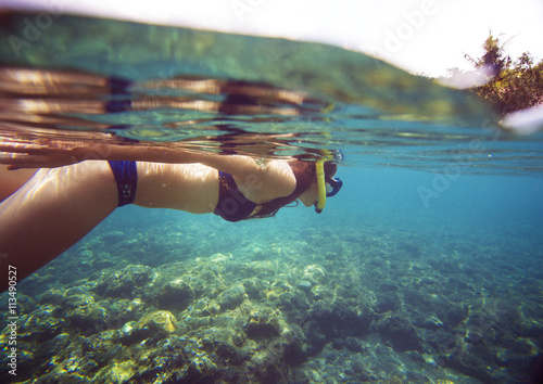 Side view of woman snorkeling in sea on sunny day photo