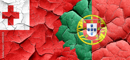 Tonga flag with Portugal flag on a grunge cracked wall