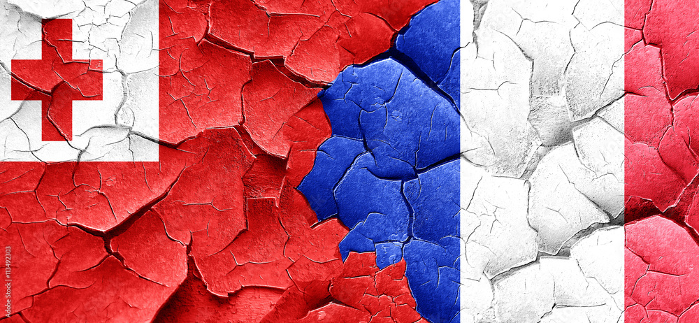 Tonga flag with France flag on a grunge cracked wall