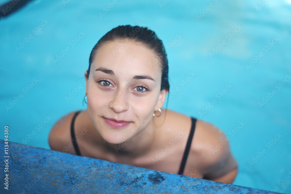 Portrait of young woman in a swimming pool. Portrait of young woman in a swimming pool.