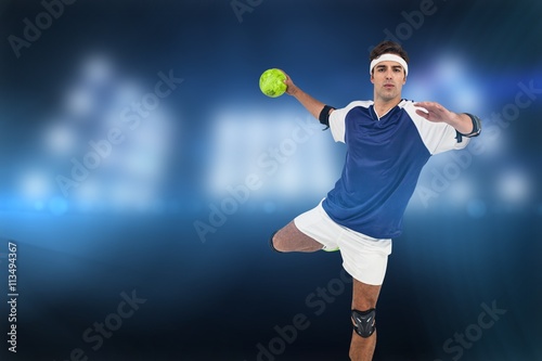 Portrait of sportsman throwing a ball against composite image of spotlight  © vectorfusionart
