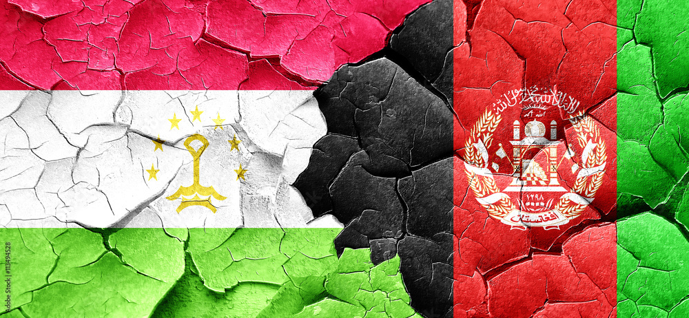 Tajikistan flag with afghanistan flag on a grunge cracked wall