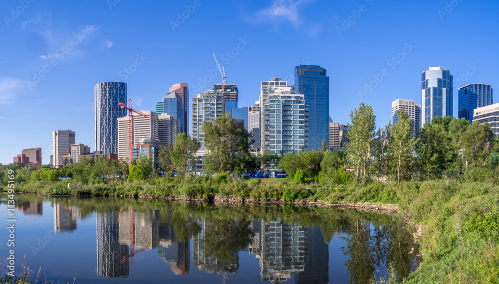 Calgary skyline reflected in a reconstructed urban wetland along the Bow River. Calgary skyline reflected in a reconstructed urban wetland along the Bow River.