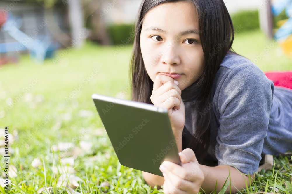 Woman Use Tablet for Relaxation at Playground Woman Use Tablet for Relaxation at Playground