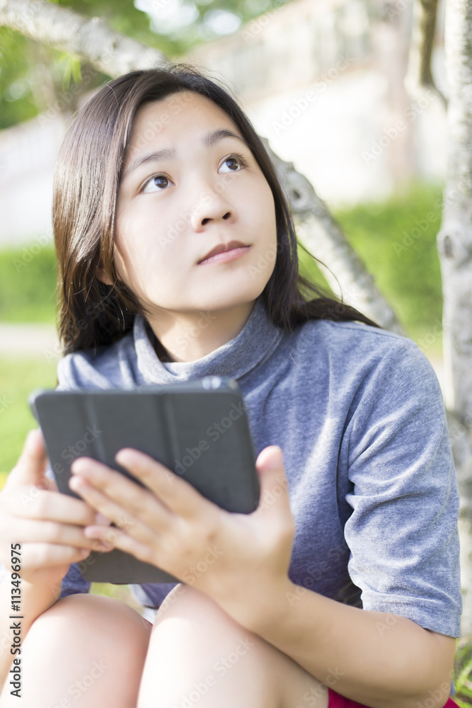 Fototapeta premium Woman Use Tablet for Relaxation at Playground