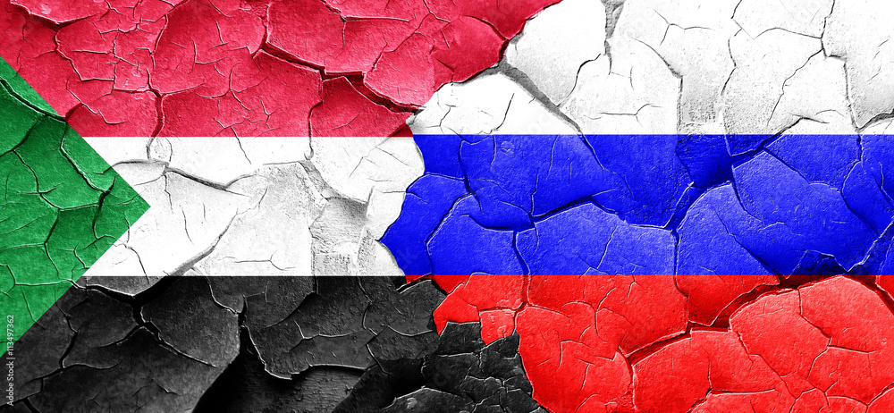 Sudan flag with Russia flag on a grunge cracked wall