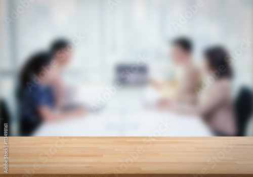 wooden table with business consult background