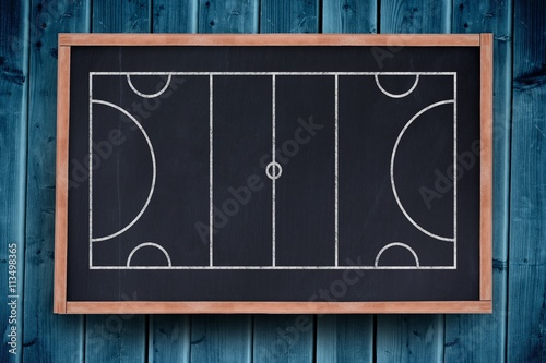 Sport field plan on a black background against blackboard with copy space on wooden board
