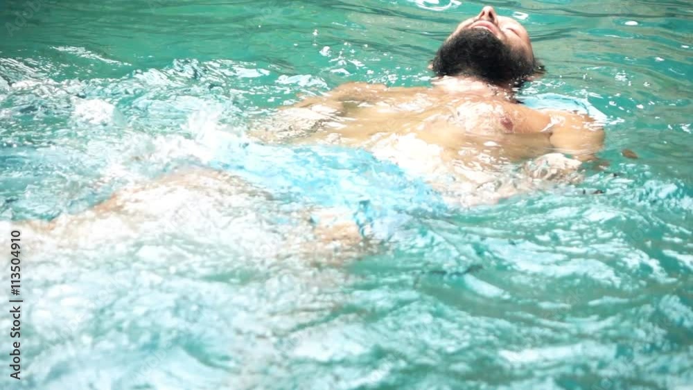 Young man swimming in the pool, super slow motion
Young man swimming in the pool, super slow motion