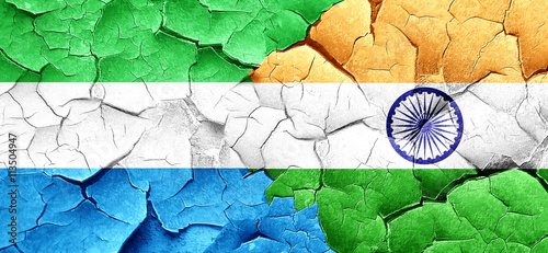 Sierra Leone flag with India flag on a grunge cracked wall