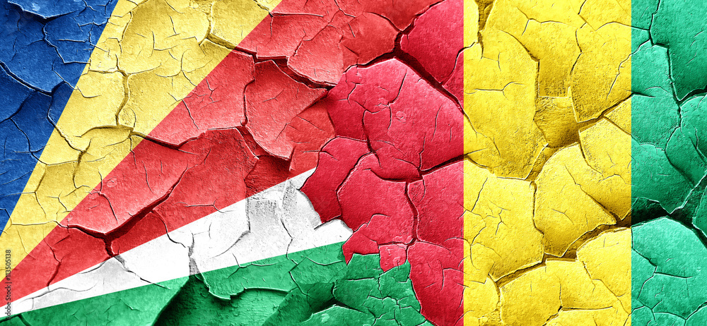 seychelles flag with Guinea flag on a grunge cracked wall