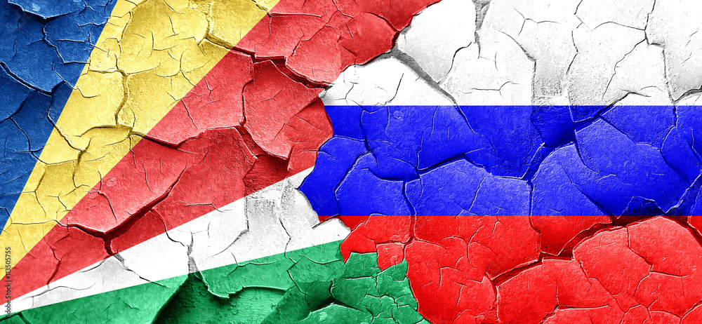 seychelles flag with Russia flag on a grunge cracked wall