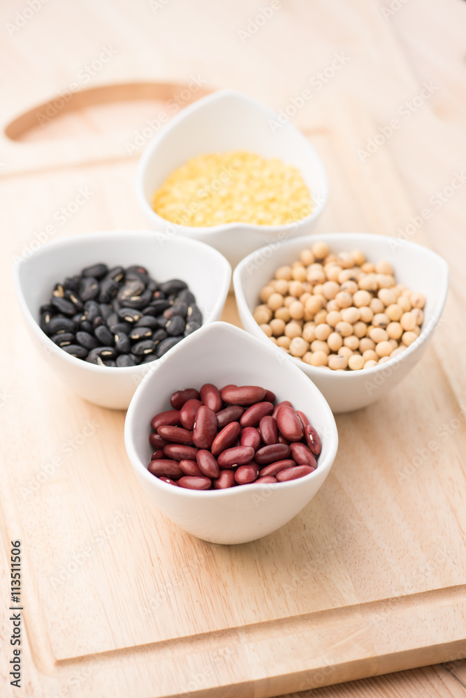 four colored beans in ceramic bowl