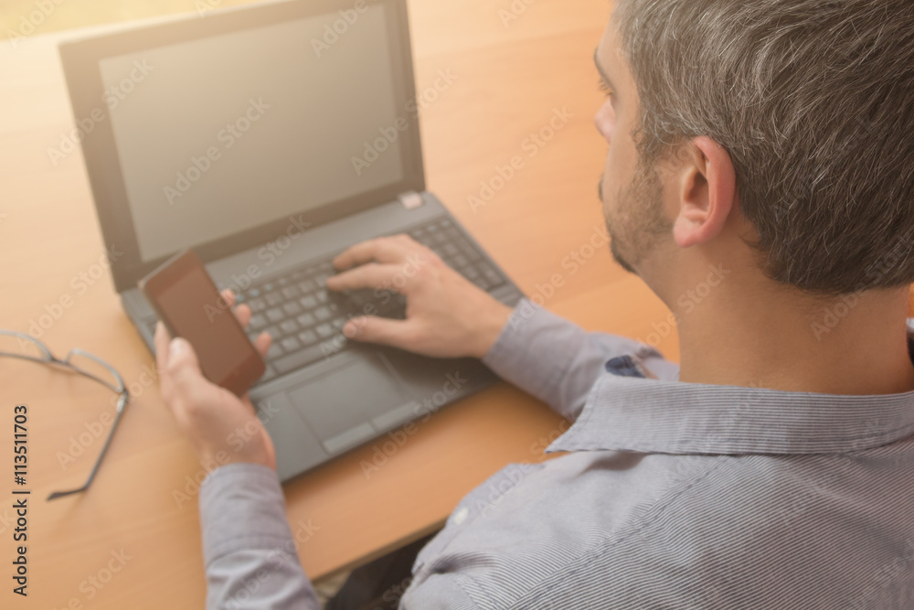 Working with a cellphone and laptop combo. Working with a cellphone and laptop combo.