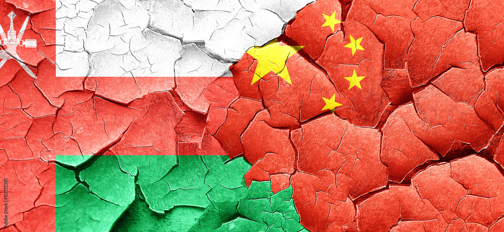 Oman flag with China flag on a grunge cracked wall