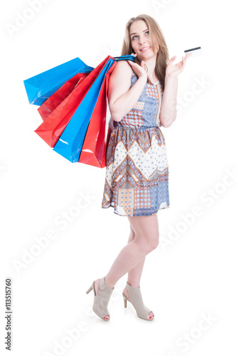 Full body of attractive young woman holding debit card