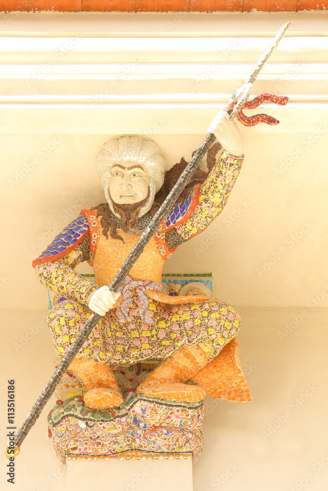 Naklejka premium BANGKOK, THAILAND - JUNE 11, 2016 : High Relief Sculpture of Arab soldier with spear decorated with ceramic mosaic at Wat Pariwat Temple, Bangkok, Thailand