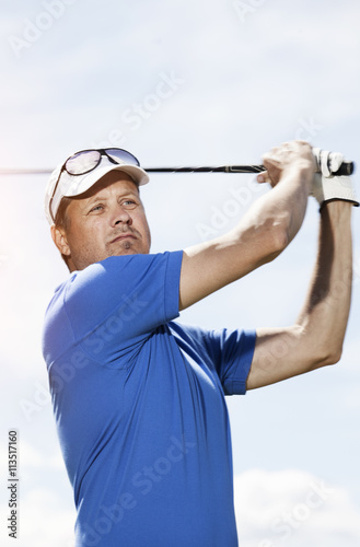 Golf player against sky